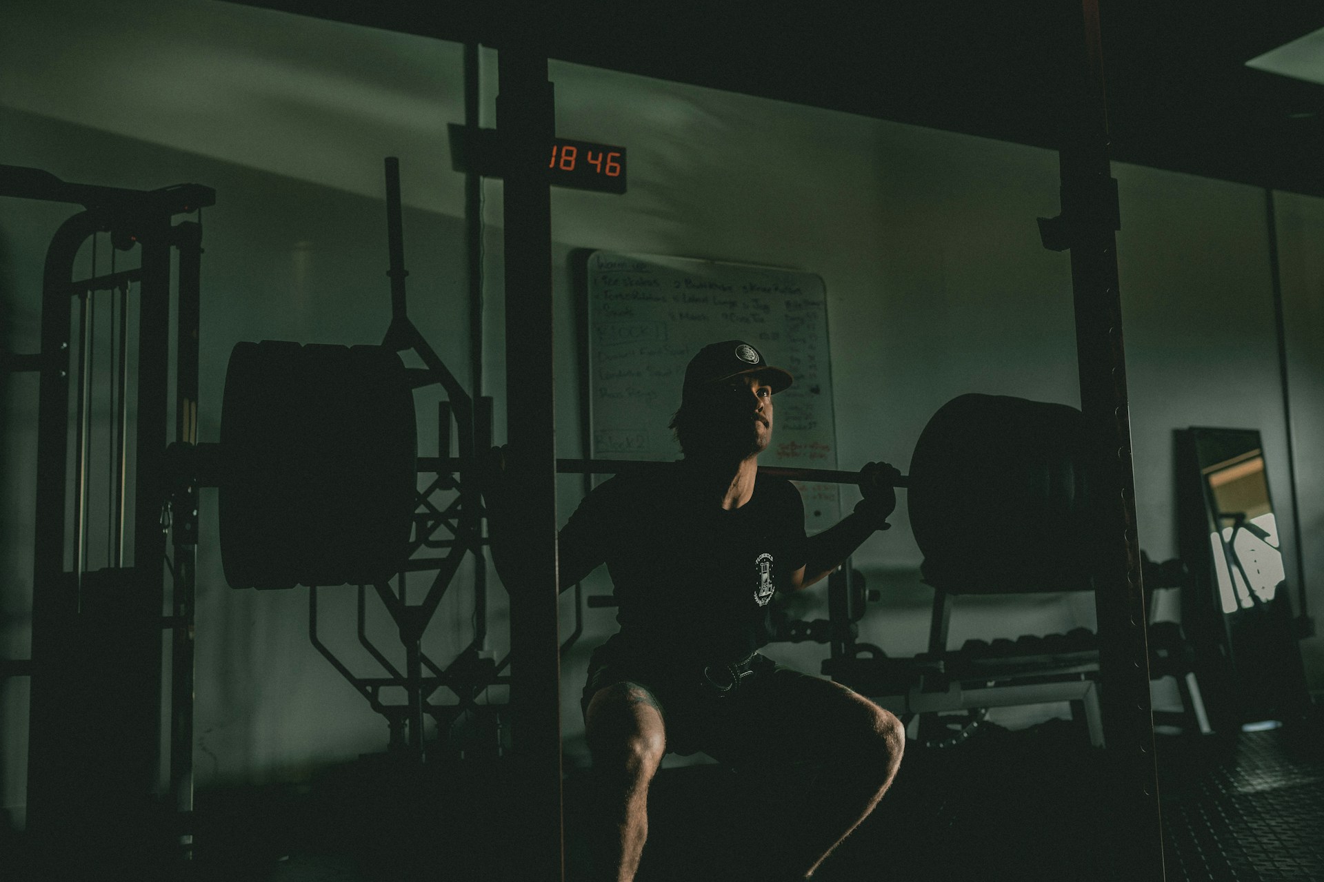 Squat training from [Unsplash](https://unsplash.com/photos/a-man-squatting-on-a-bench-in-a-gym-XTktUgGYEkI)